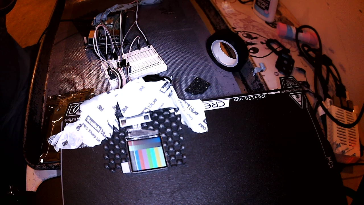 The 1.3 inch prototype screen on a 3D printer bed showing colour bars, wired to a breadboard and a Raspberry Pi 3